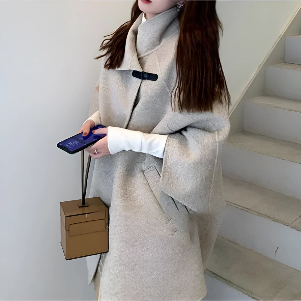 Women's oatmeal coloured acrylic coat with flight sleeves showing 100cm length