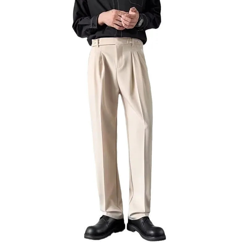Man wearing straight-loose fit suit trousers in apricot colour, showcasing the leg cut and formal style.