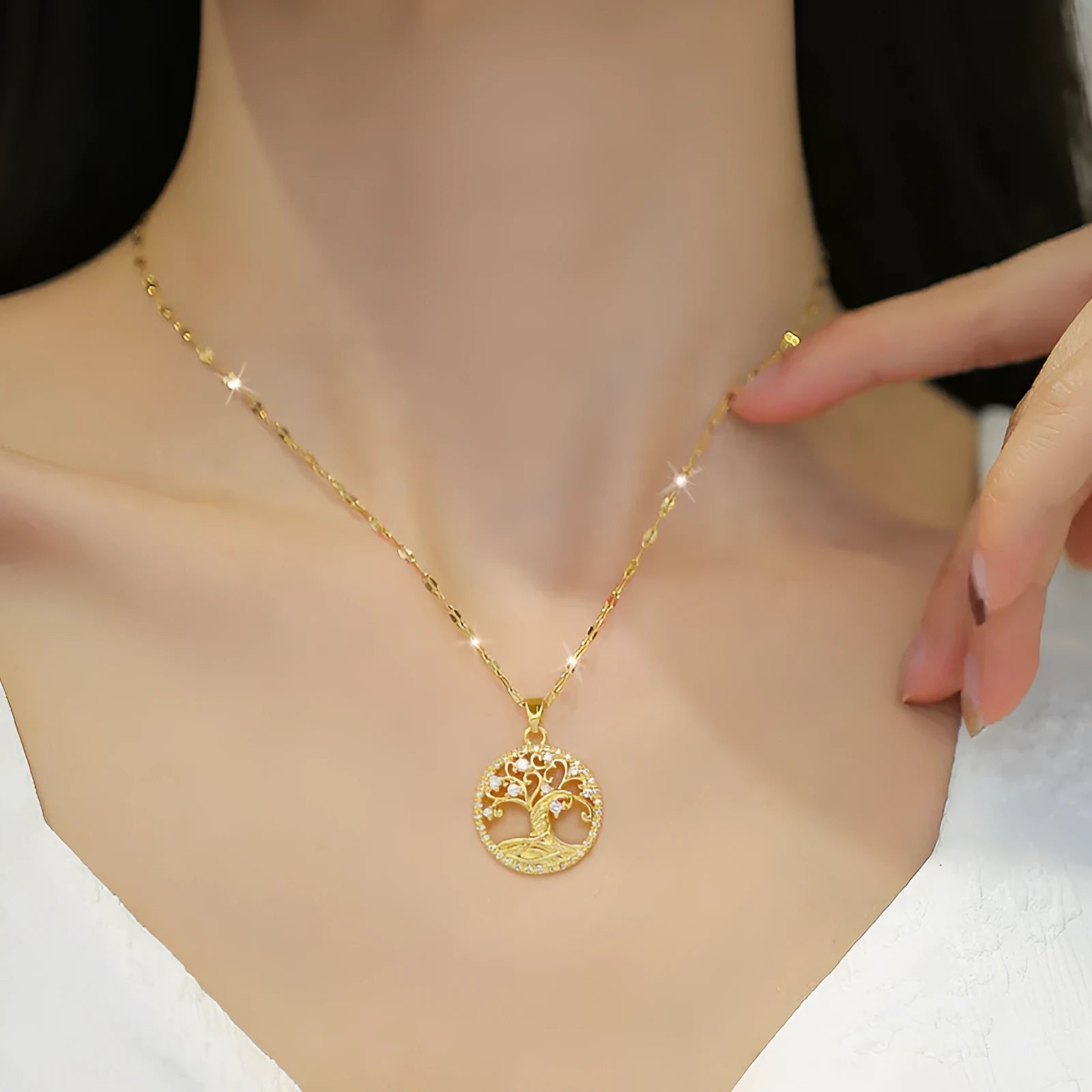Gold-plated adjustable necklace with a detailed rhinestone and mother-of-pearl lucky tree light pendant.