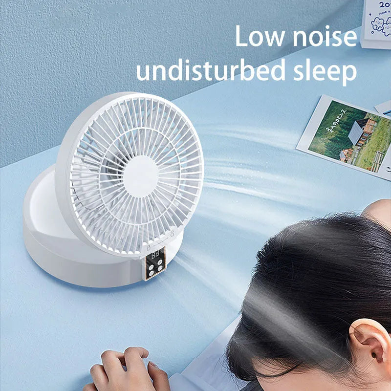 White portable folding electric fan with night light and remote control on a desk