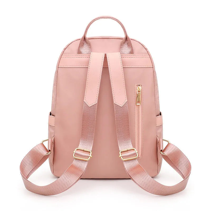 Black nylon women's casual backpack with internal pockets and double shoulder straps.