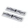 A pair of silver zinc alloy car badge labels with coloured national flag designs, shown at 58mm by 14mm scale.