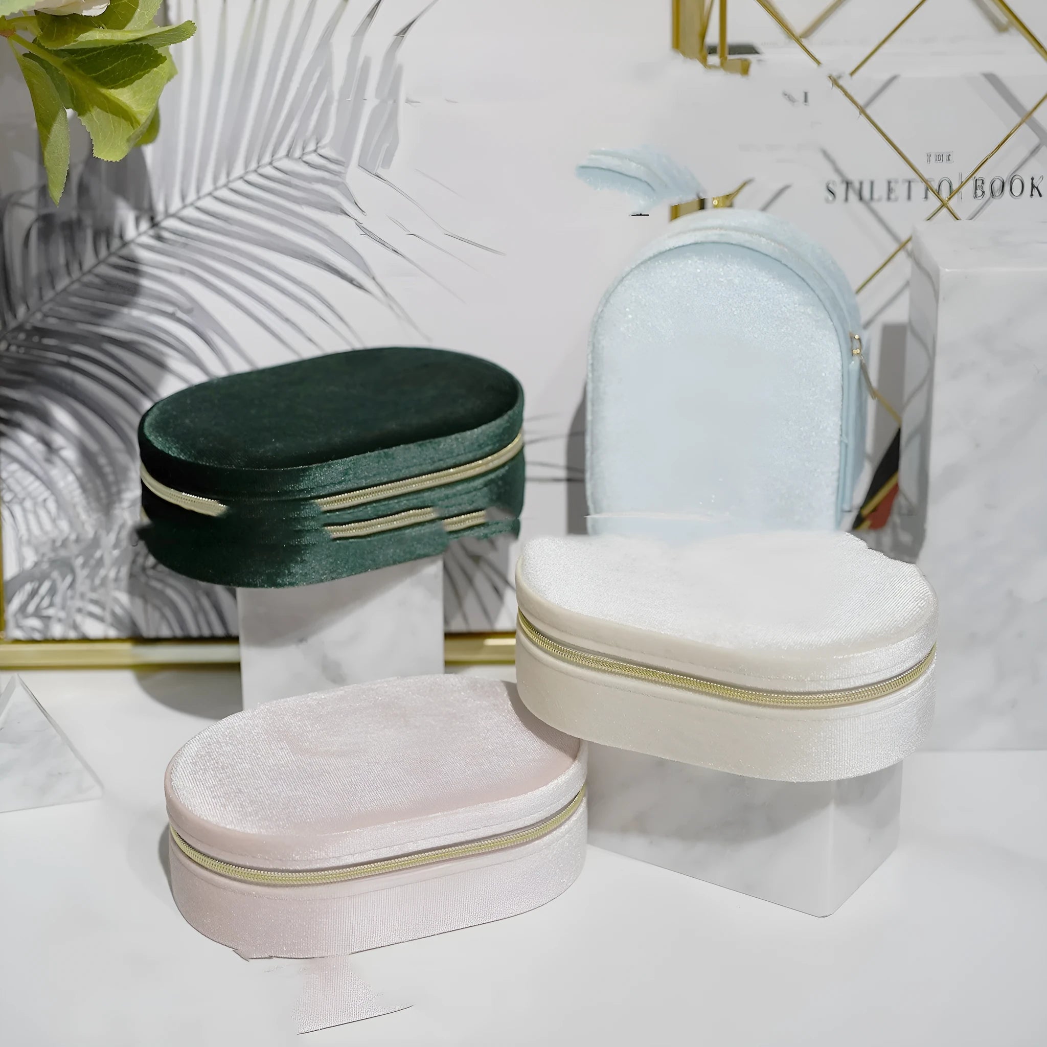 Oval velvet jewelry storage box in lake blue colour with flannel lining, shown open.