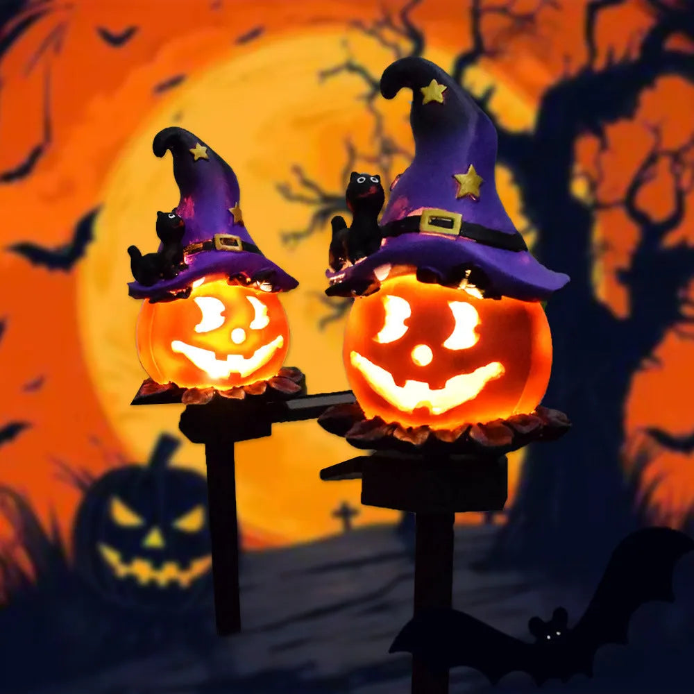 Solar Halloween pumpkin lantern with wizard pumpkin style on a garden path, wrought iron frame