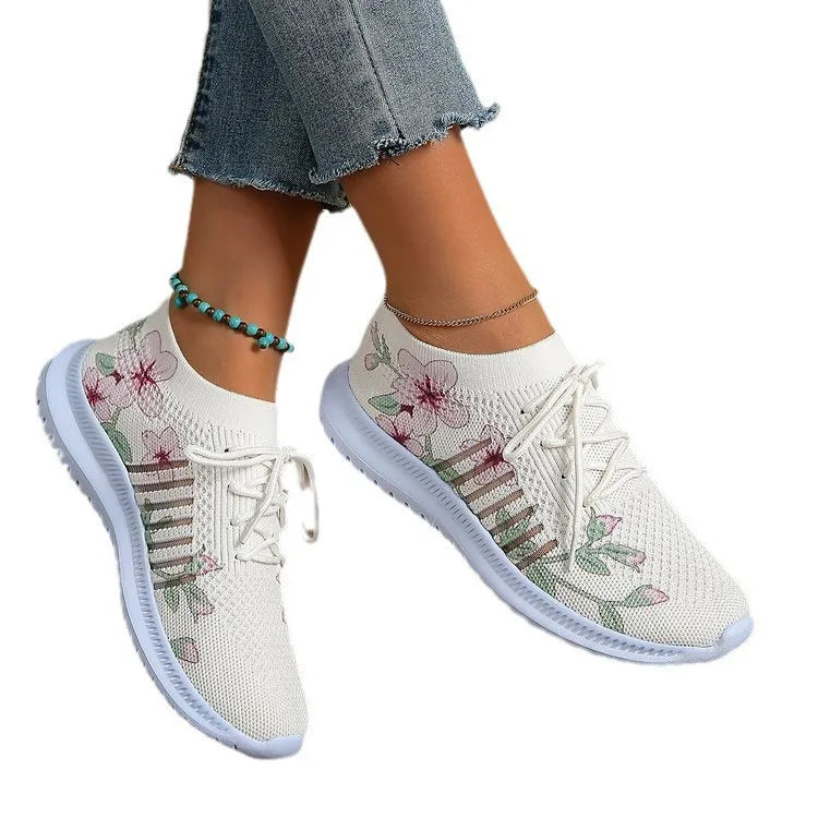 Milky white women's casual running shoes with mesh flyknit upper and rubber sole.