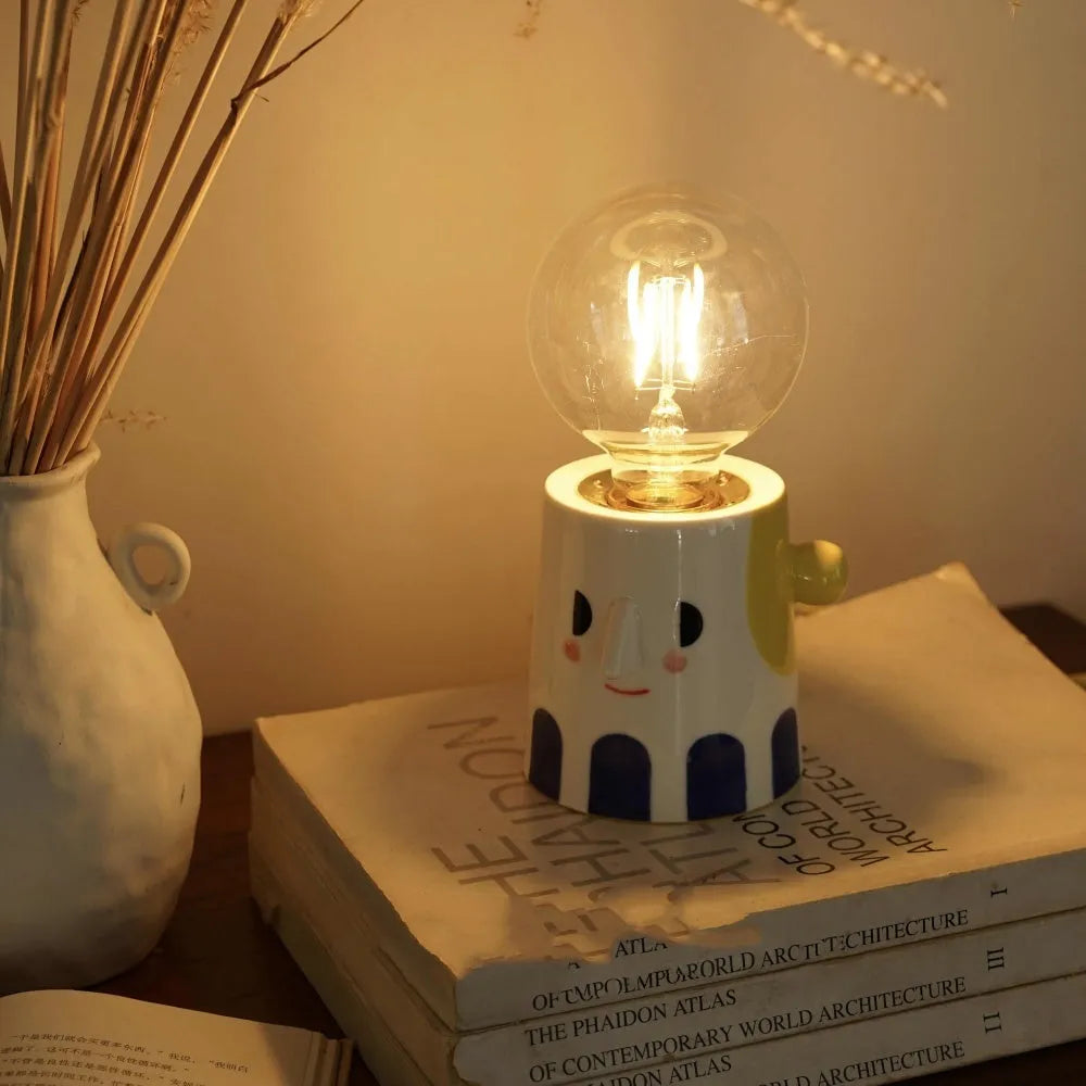 Handmade ceramic table lamp with a spherical ball headlight design on a solid ceramic base.