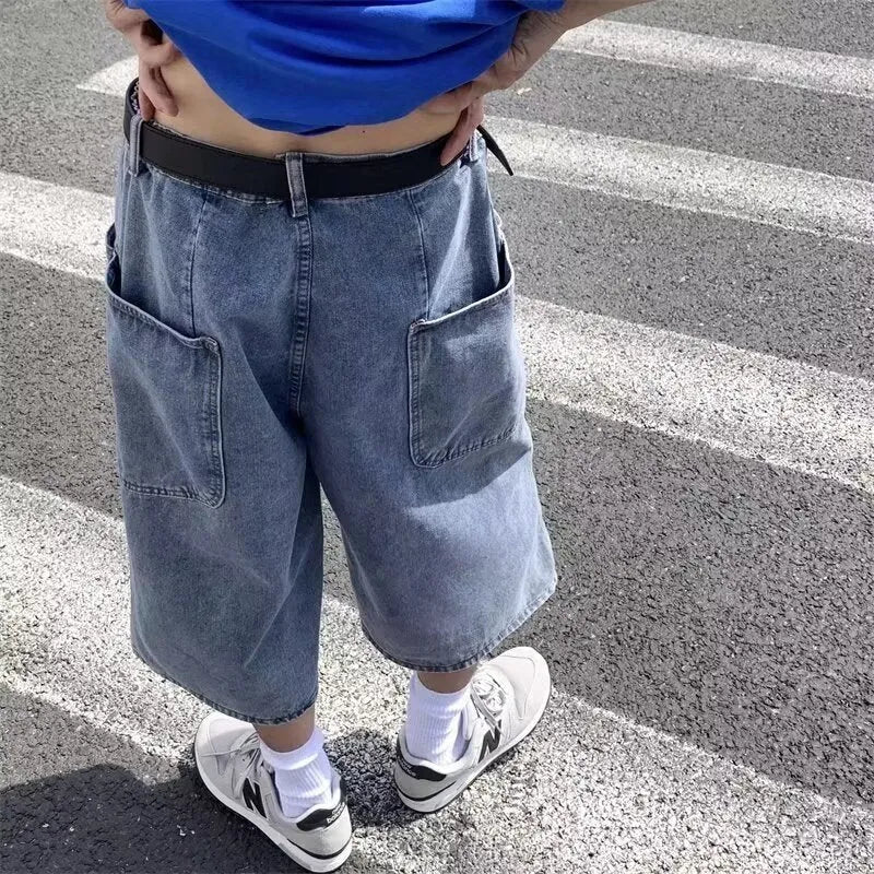 Blue washed denim pirate shorts for men with a high waist, cropped length, and straight legs on a zipper fly.