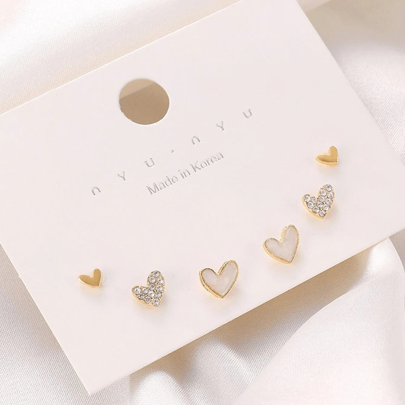 Women's heart shape earrings suit with three pairs in gold, black, black white, and pink colours
