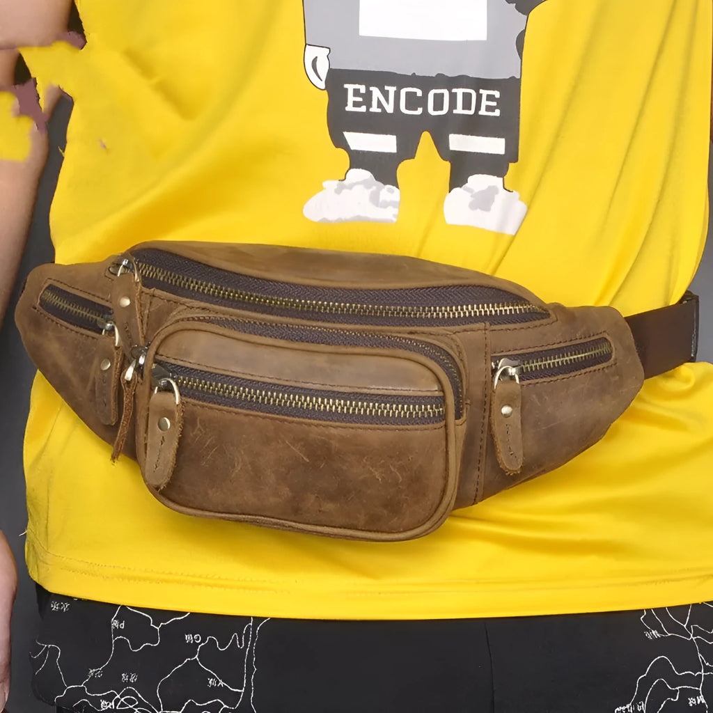 Brown leather shoulder messenger bag with adjustable strap showing interior compartments