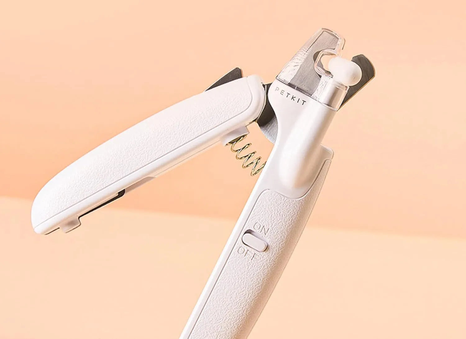 White pet nail clippers with LED light on the handle and a clear anti-splash guard covering the blades.