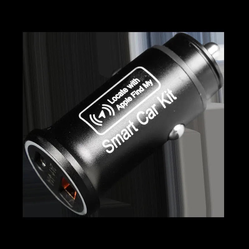 Black ABS plastic car charger locator GPS setting instrument on a dark surface.