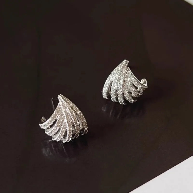 A pair of platinum-coloured geometric line design zircon earrings.