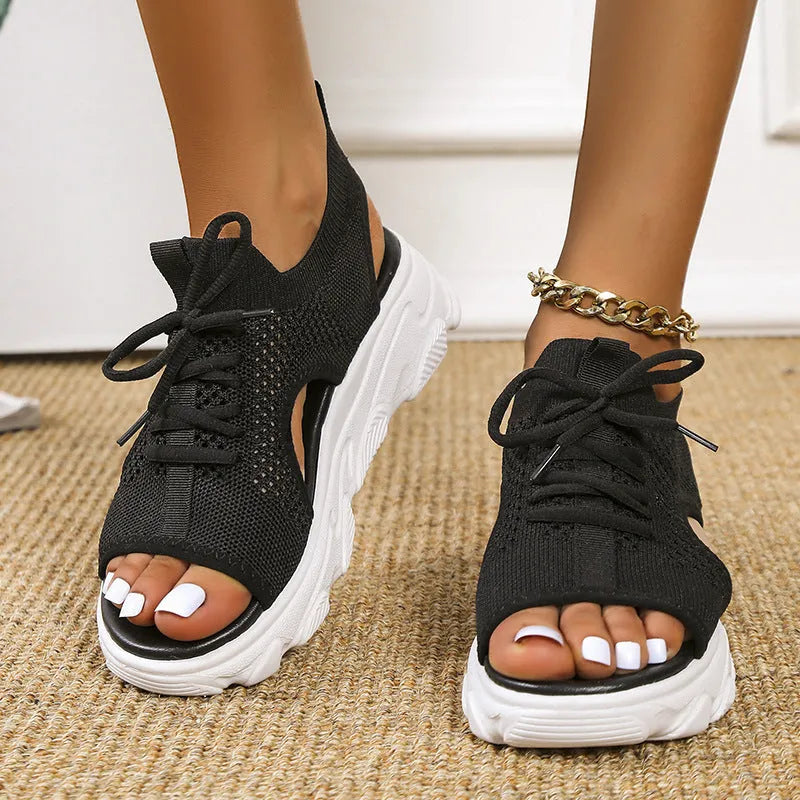 Lace-up sandals for women with thick rubber sole and mesh upper in orange colour, flat design