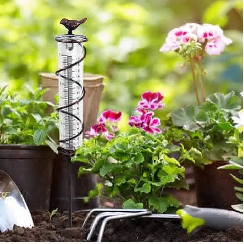 Cast iron garden rain gauge with decorative hummingbird design showing measurement scale