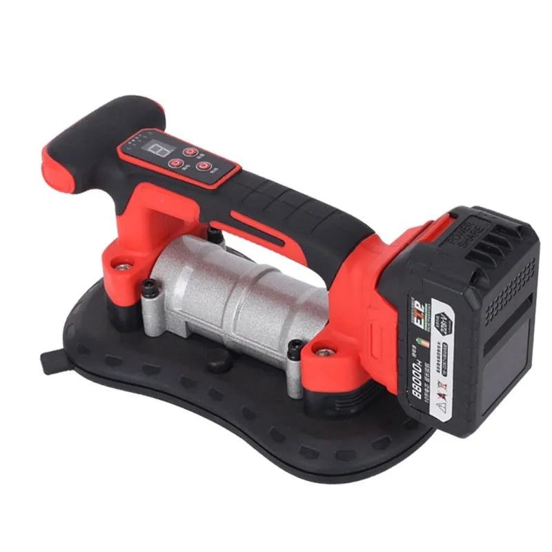 Cordless tile laying machine with battery, shown handling a large format tile