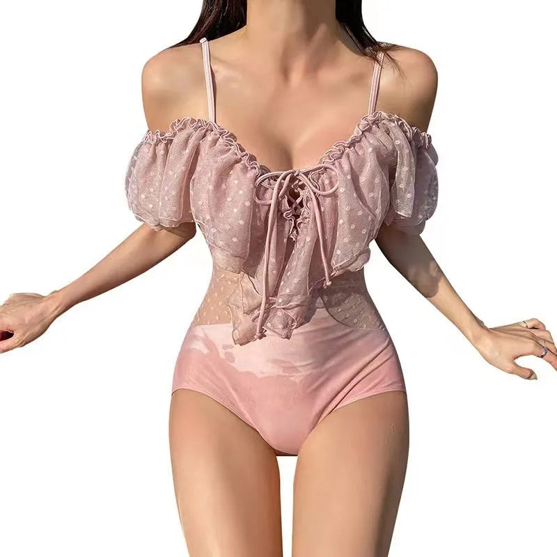 Pink solid colour women's one-piece swimsuit on a mannequin.