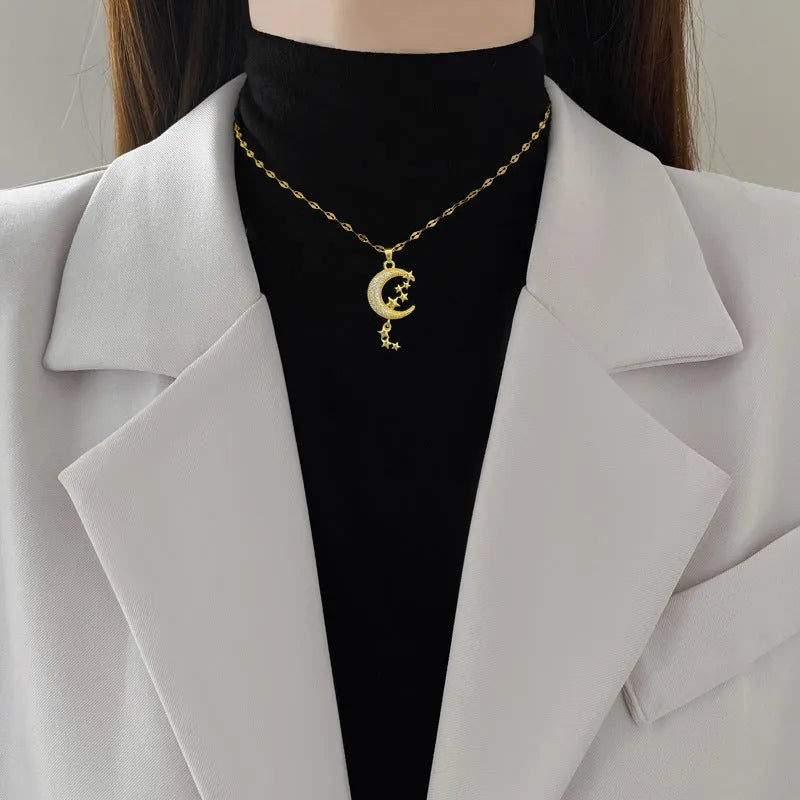 Geometric moon pendant necklace on a stainless steel chain with a copper accent.