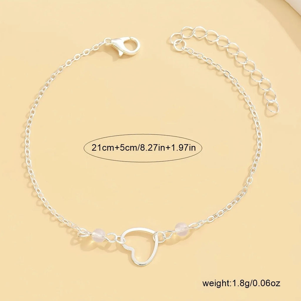 Adjustable women's anklet with heart-shaped pendant in gold and silver alloy finishes