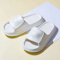 A pair of soft, thick-soled EVA flip-flop slippers in a chosen colour, showing the non-slip tread pattern on the sole.