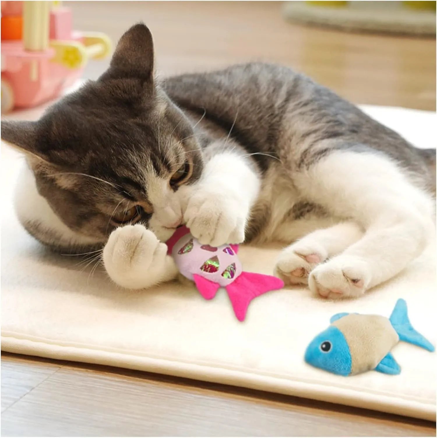 Blue, orange and pink fish-shaped cat toys with plush exterior and crinkle paper elements