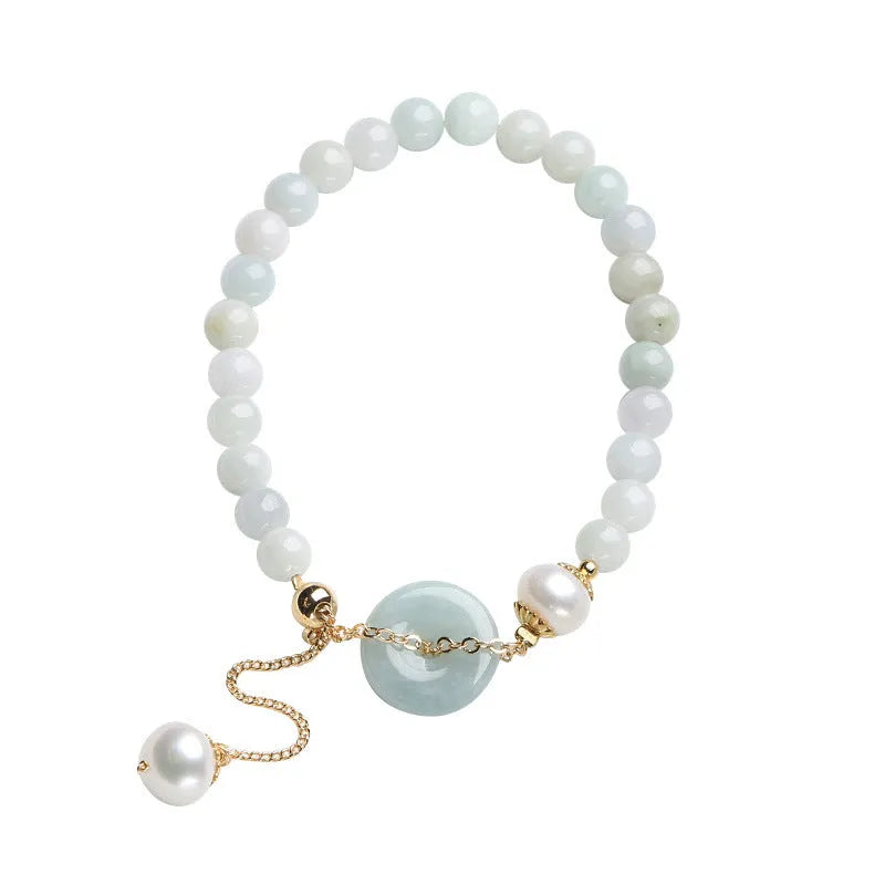 Natural jade bracelet with geometric shape, round pendant, and peace buckle closure on a wrist.