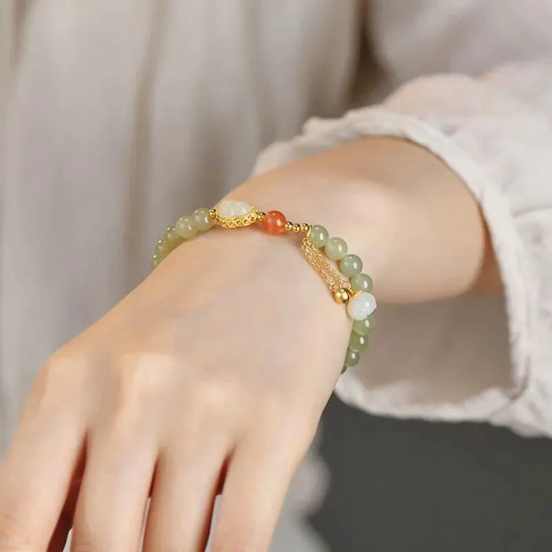 Qingshui jade bracelet with gold plated gourd charm and fu character pendant on adjustable cord