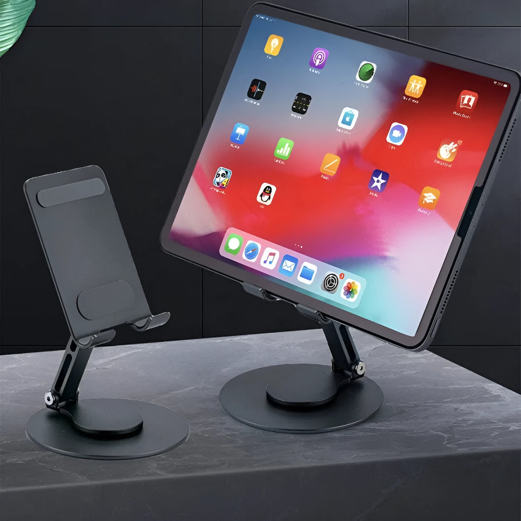 Grey aluminium alloy rotating mobile phone bracket on desk with silica gel grip, 4.8 x 4.2 x 1.4 cm, holding a smartphone in landscape mode