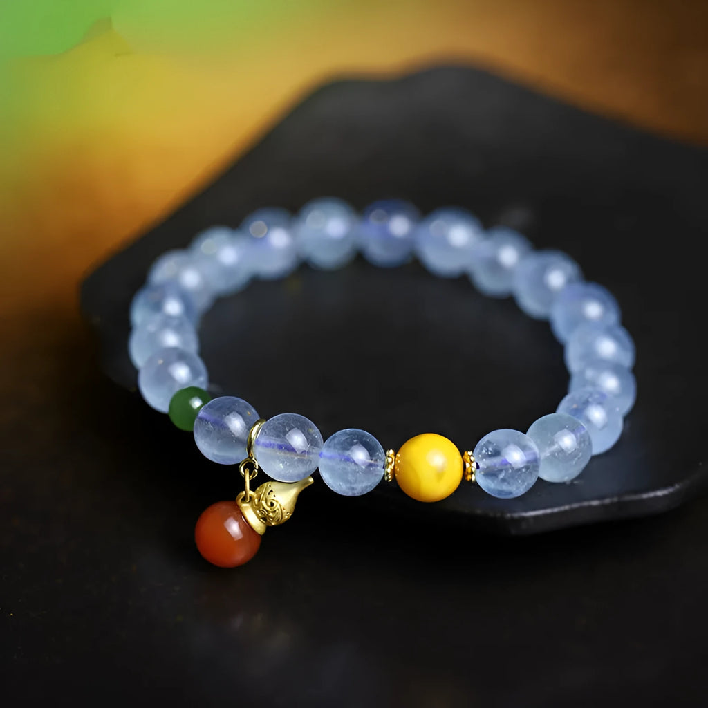 Geometric women's bracelet with 8mm iced aquamarine stones on a wrist.