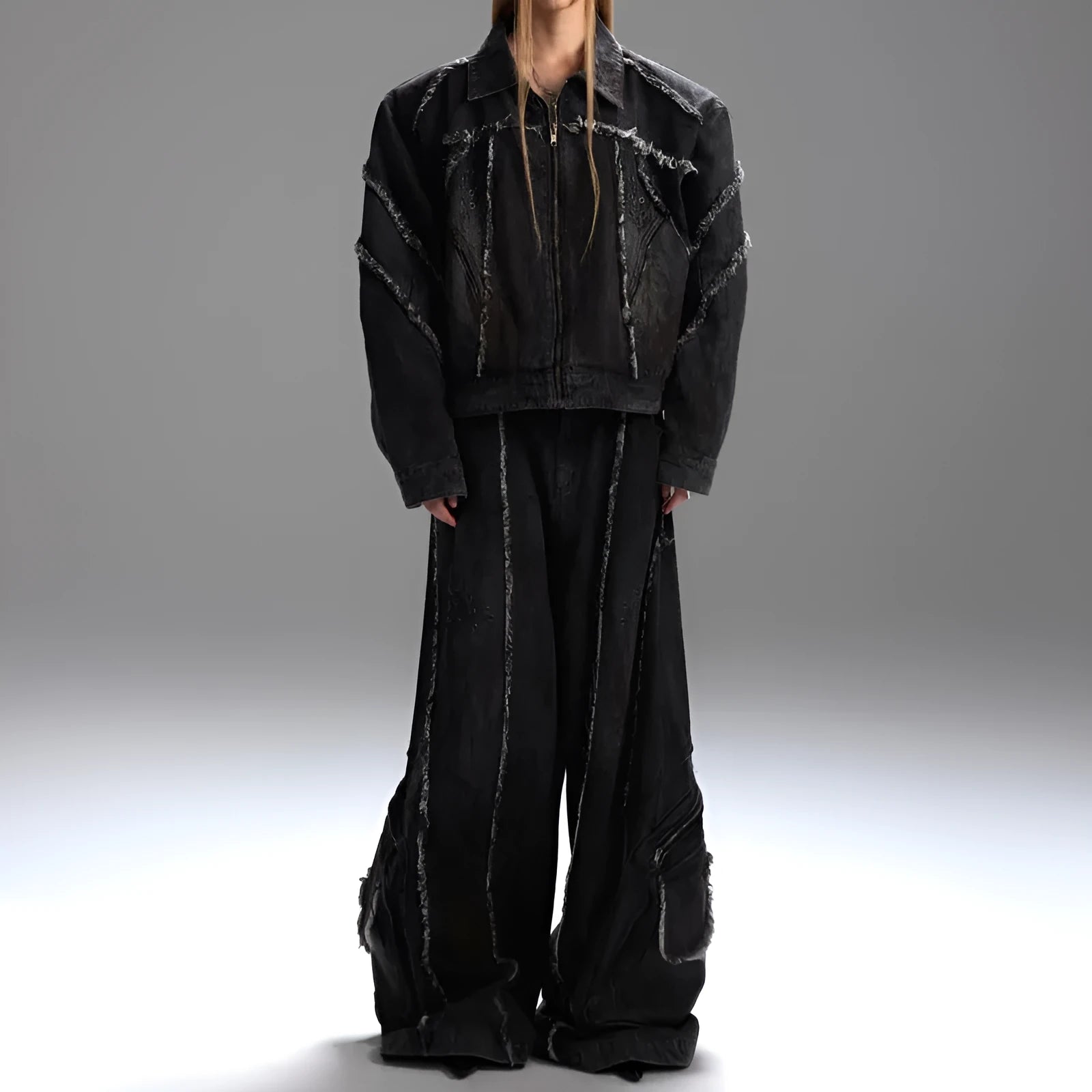 Black denim coat and trouser set with distressed raw edges and a splash-dye gradient pattern.