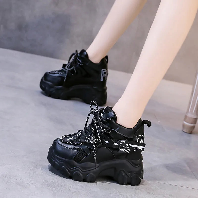 White women's platform sports shoes with mesh upper, cross strap, and a thick rubber sole.