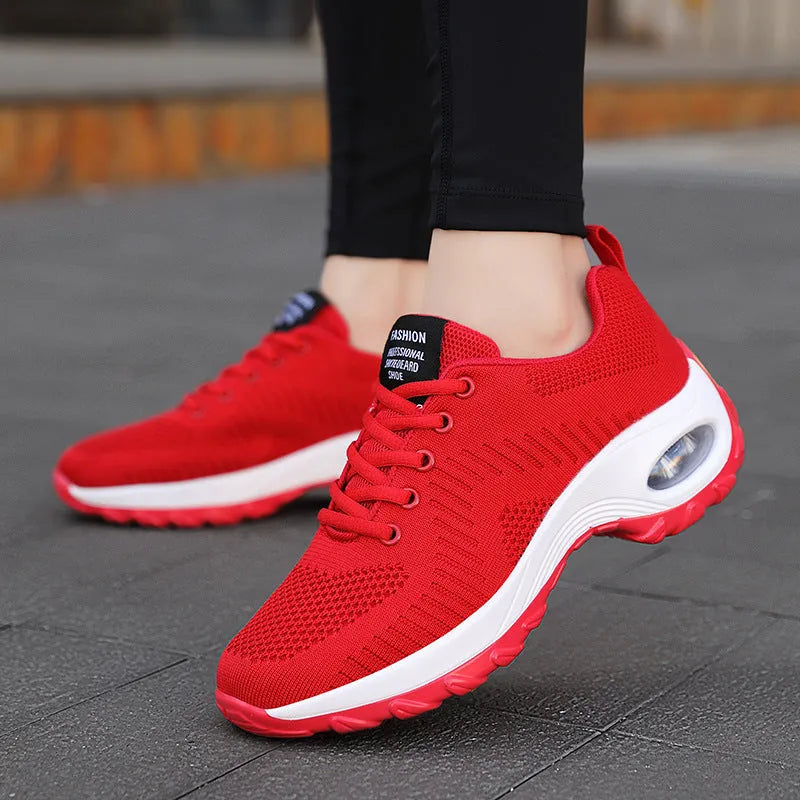 Red low-top women's mesh sneakers with front lace-up and round toe on a flat PU sole.
