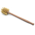 Large long handle cleaning brush with beech wood handle and natural sisal bristles on a wooden surface