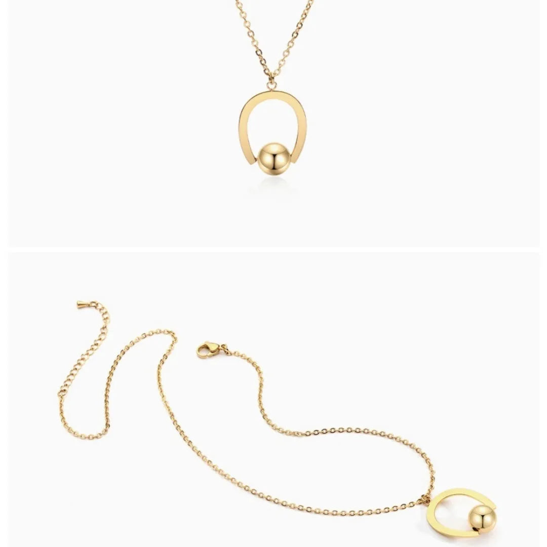 Gold electroplated stainless steel necklace with geometric pendant on an adjustable chain.