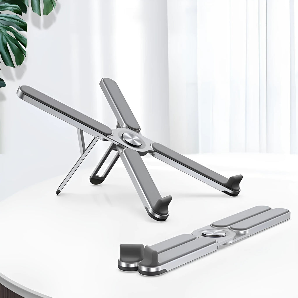 Foldable aluminium alloy laptop bracket in silver raised on a desk surface