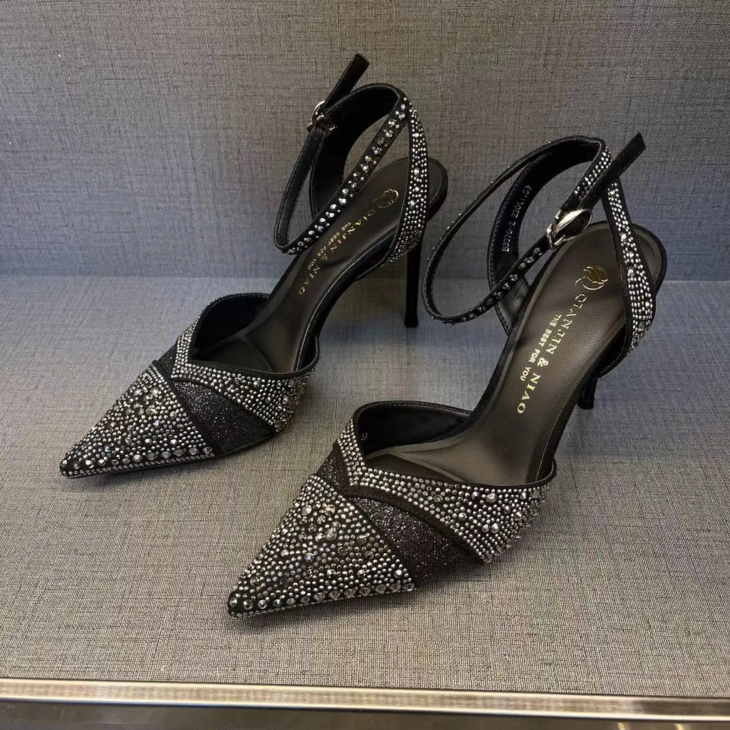 Women's black and silver hollow high heels with a red sole and pointed stiletto toe.