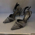 Women's black and silver hollow high heels with a red sole and pointed stiletto toe.