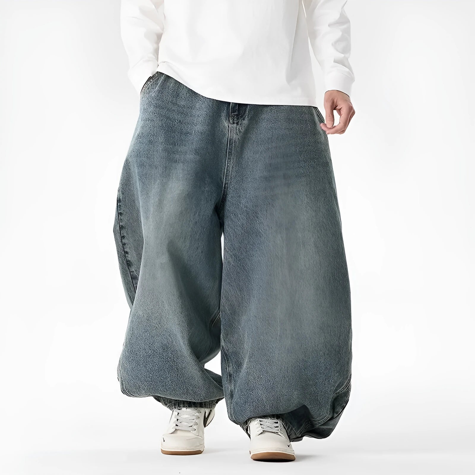 Men's plus size baggy blue denim jeans with a straight leg and low waist on a hanger.