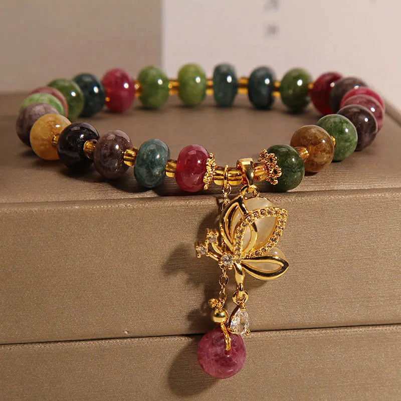 Colourful butterfly bracelet with alloy base and glass beads in tourmaline shades.