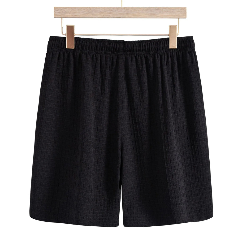 Men's white cotton blend short sleeve shirt and matching shorts beach suit laid flat.
