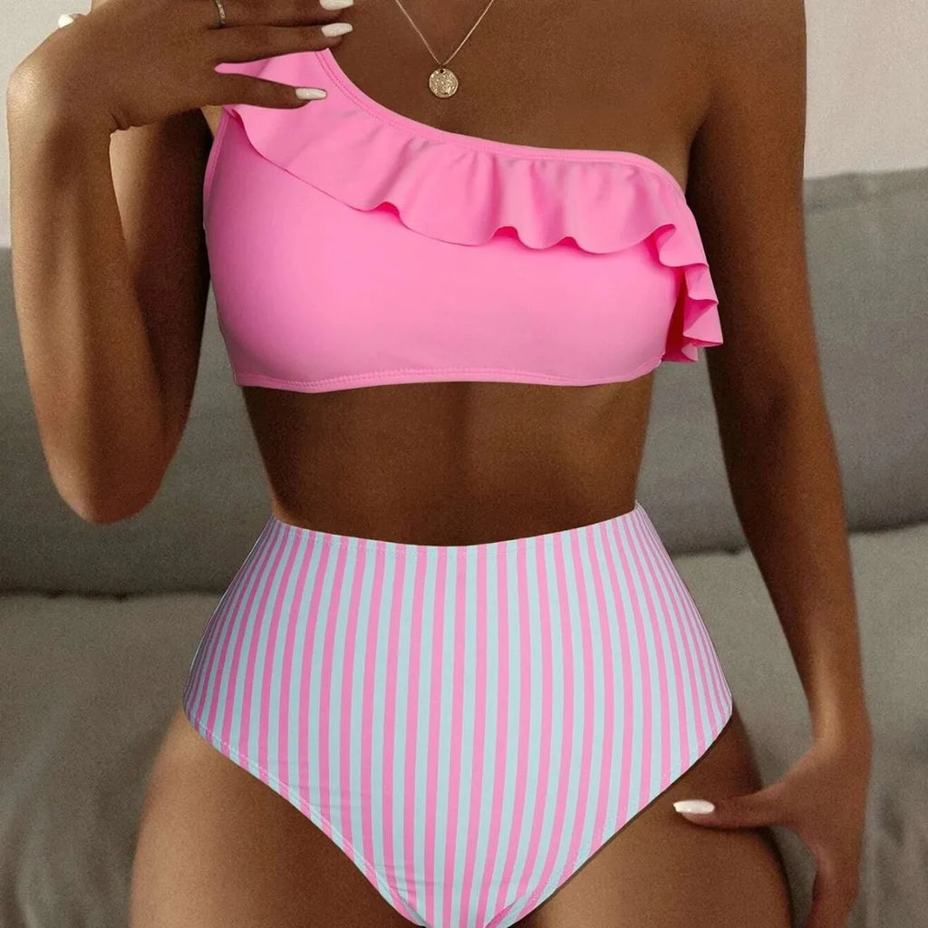 Women's striped and solid colour two-piece bikini swimsuit on a neutral background