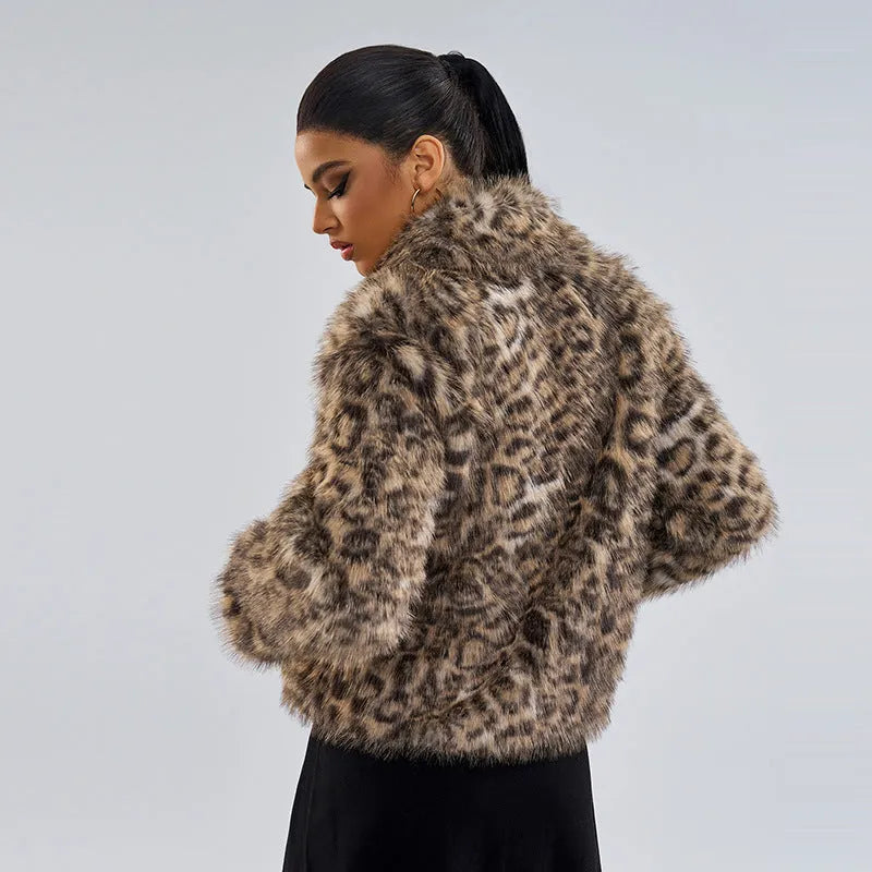 Women's leopard print coat with a buckle lapel, shown in street fashion style.