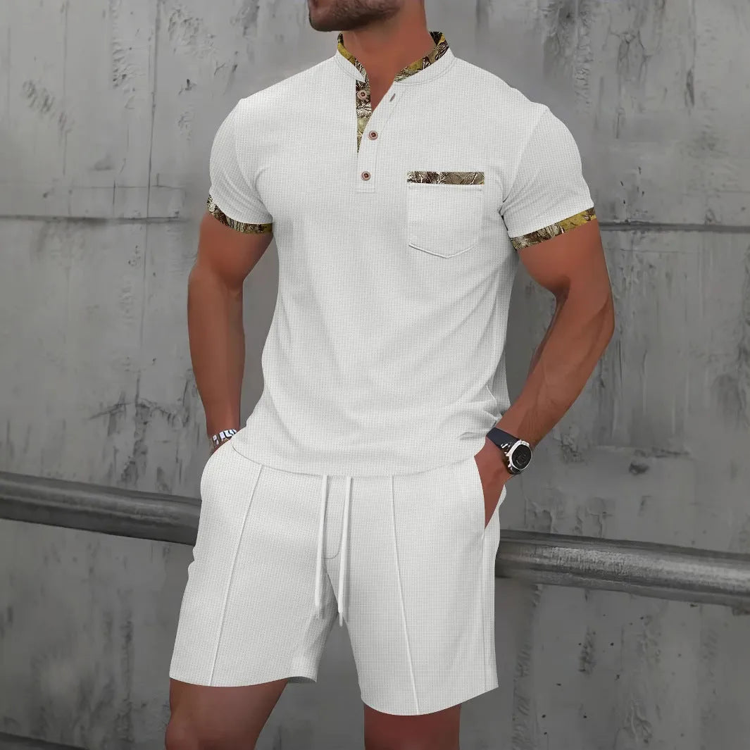 Men's grey zip-front polo collar tracksuit top and shorts set laid flat.