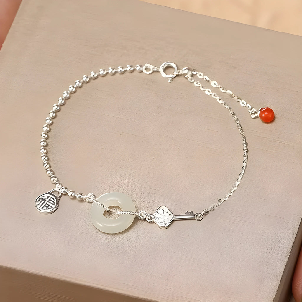 Silver Hetian jade bracelet with peace buckle charm and Chinese Ruyi Xiaofu design for women