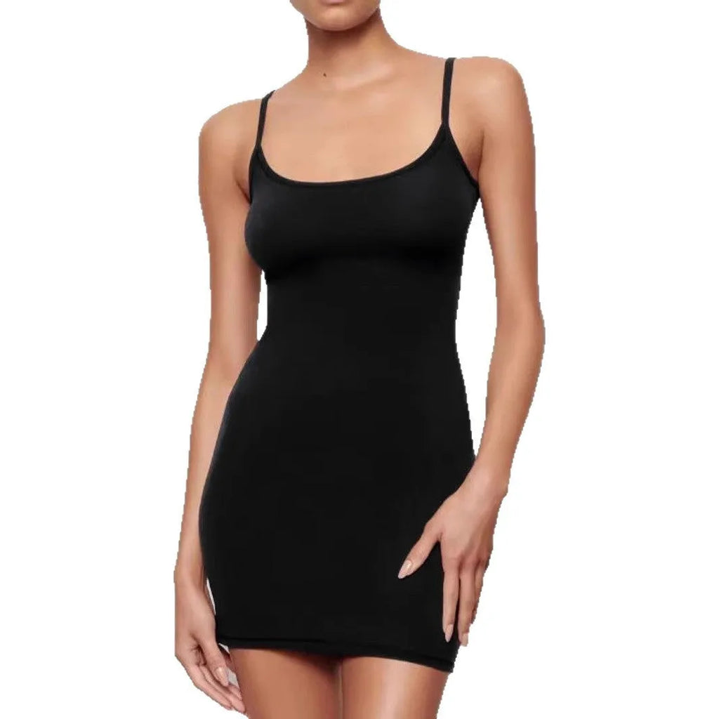 Black sleeveless sling dress with a short skirt and a slim sheath silhouette on a mannequin.