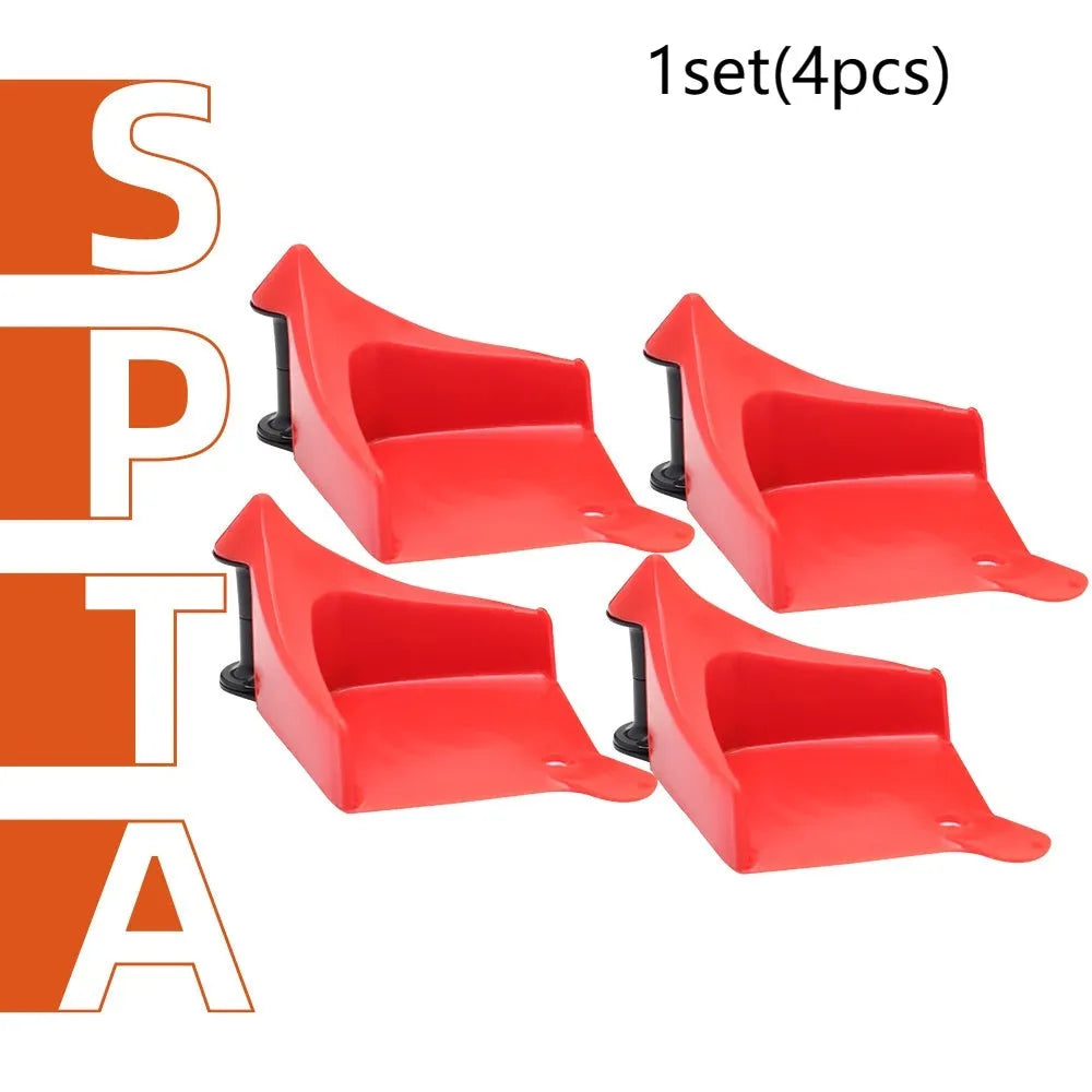 Set of four red plastic and black rubber triangle car parking blocks or wheel stops