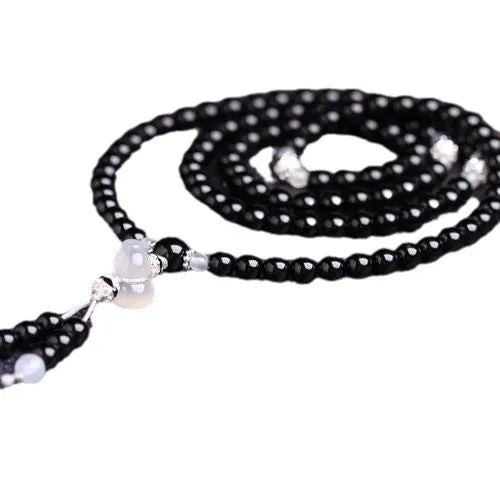 Black agate 108 bead unisex geometric bracelet with number elements.