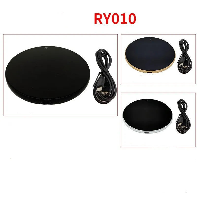 Black USB heating coaster pad for cups with LED indicator light on a wooden desk.
