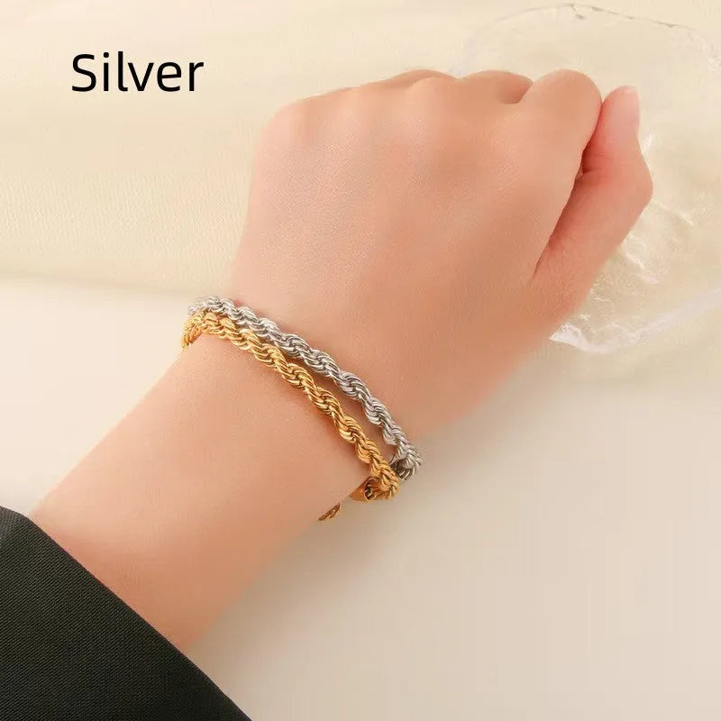 Alloy hip-hop twist bracelet for men in gold geometric chain style on a surface