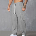 Men's loose-fitting corduroy cargo trousers in navy blue with a drawstring waist and straight wide legs.