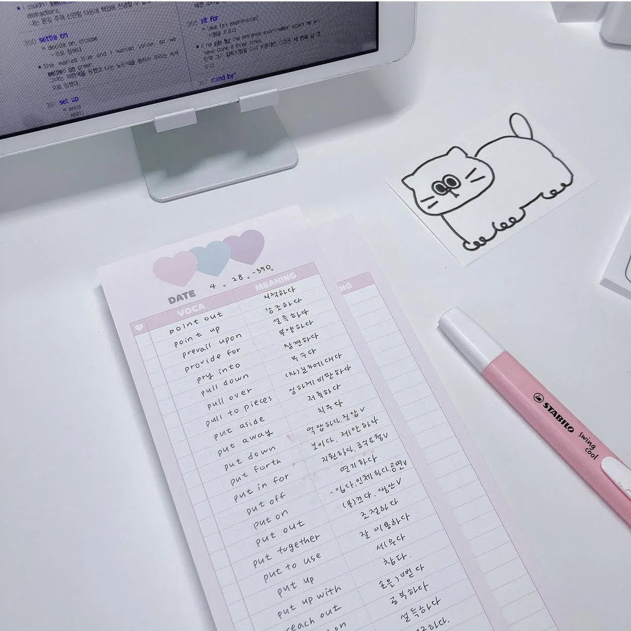 Vertical format English vocabulary notepad in B5 half size showing pink cover and double-sided printed pages